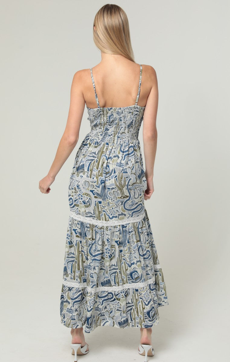 An elegant maxi dress featuring a V-neck, twist-front bodice, cut-out waist, and delicate lace trim.