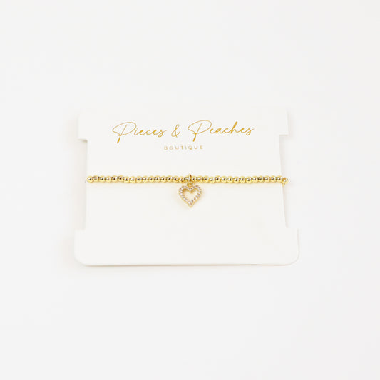 A chic and meaningful 14K gold-plated bracelet with 3mm beads and a classic heart charm, symbolizing love and connection.