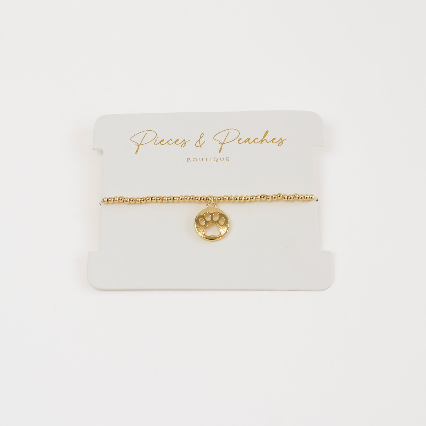 A dainty 14K gold-plated bracelet with 3mm beads and a delicate paw charm, perfect for pet lovers.