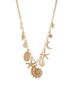 A gold-tone charm necklace featuring ocean-inspired accents like a spiral seashell, starfish, and celestial charms, perfect for a beachy, bohemian look.