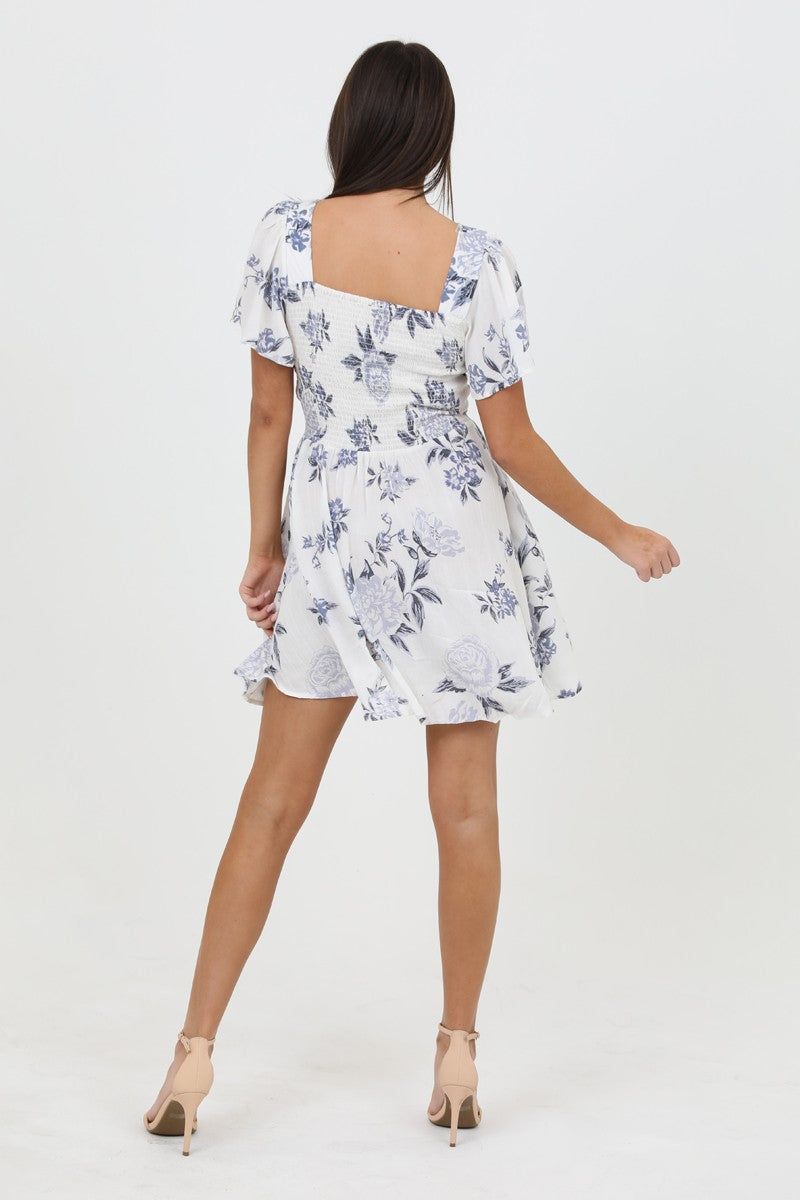 Blue Blossom Knot-Front Dress with a feminine floral print, featuring a front knot cutout and flowy silhouette.