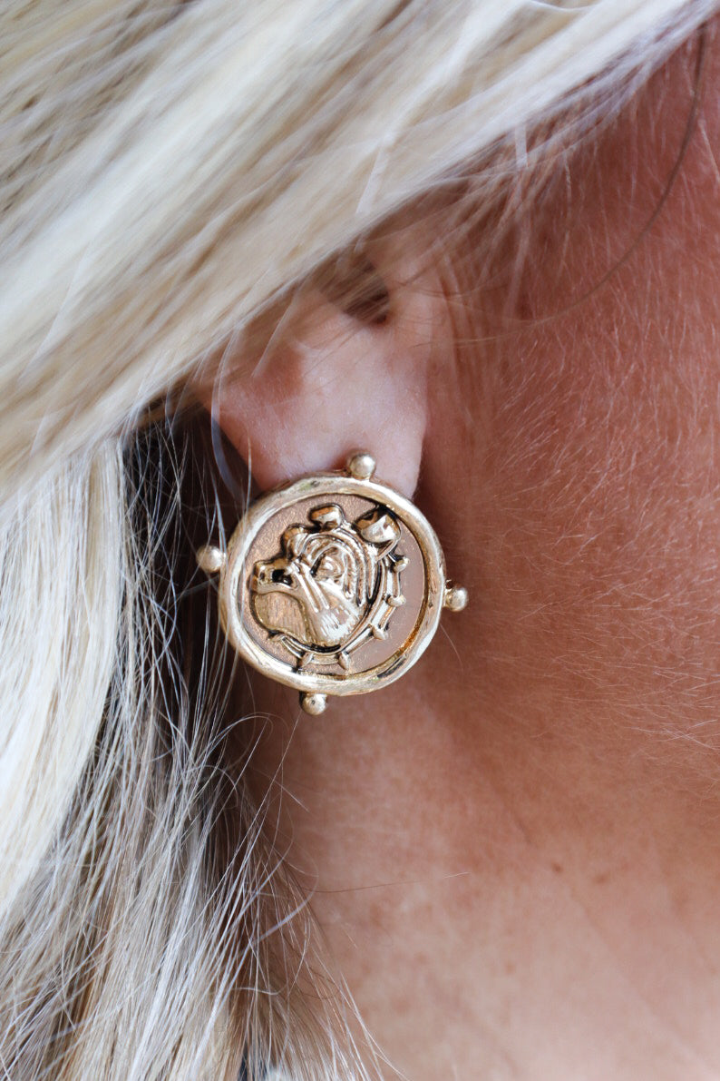 Gold coin stud earrings featuring an embossed bulldog design, inspired by vintage coin jewelry.