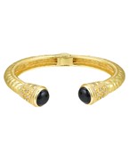 Gold-plated cuff bracelet with intricate engravings, featuring elegant gemstone accents