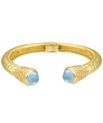 Gold-plated cuff bracelet with intricate engravings, featuring elegant gemstone accents