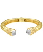 Gold-plated cuff bracelet with intricate engravings, featuring elegant gemstone accents
