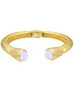 Gold-plated cuff bracelet with intricate engravings, featuring elegant gemstone accents