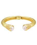 Gold-plated cuff bracelet with intricate engravings, featuring elegant gemstone accents