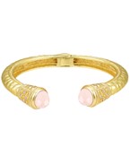Gold-plated cuff bracelet with intricate engravings, featuring elegant gemstone accents