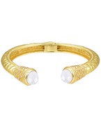 Gold-plated cuff bracelet with intricate engravings, featuring elegant gemstone accents