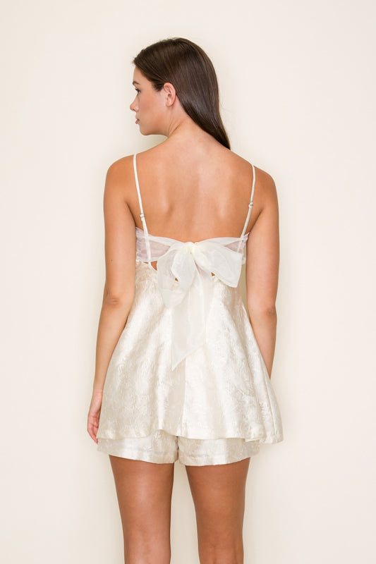 Chic jacquard romper with an open bow-back design for an effortlessly feminine look.