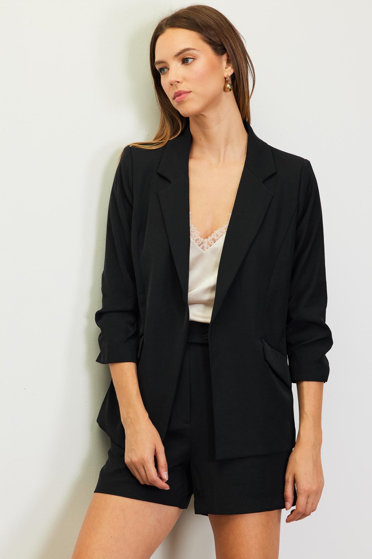 Eco-friendly blazer with shirred sleeves and functional pockets.