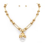 Elegant gold-tone statement necklace featuring a bold chain and a pearl and crystal centerpiece, paired with simple pearl stud earrings for a classy and coordinated look.