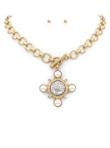 Gold chain necklace with a circular cross pendant adorned with pearls and a radiant center stone, secured with a toggle clasp