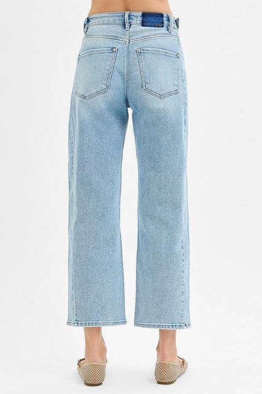Back view of women’s barrel leg jeans in light blue wash.