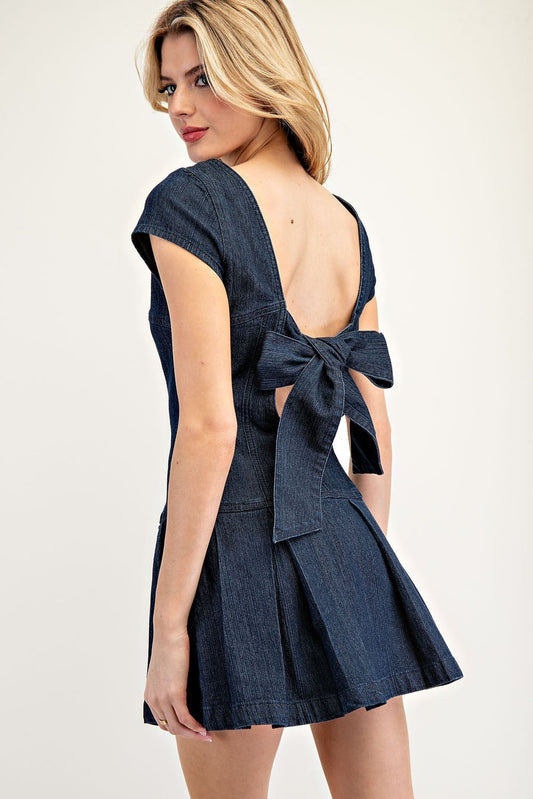Feminine denim mini dress with pleated skirt and ribbon-tie open back.