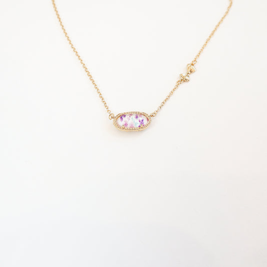 Elegant purple floral pendant necklace with a reversible bow-accented back, offering two unique styles