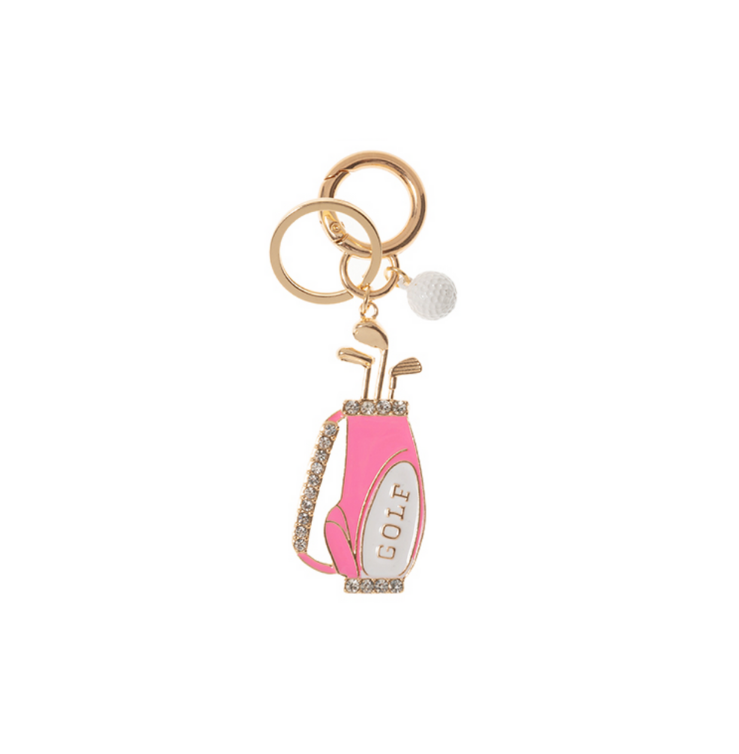 A gold-tone keychain featuring a pink enamel golf bag with sparkling crystal accents, mini golf clubs, and a white golf ball charm, perfect for golf lovers.
