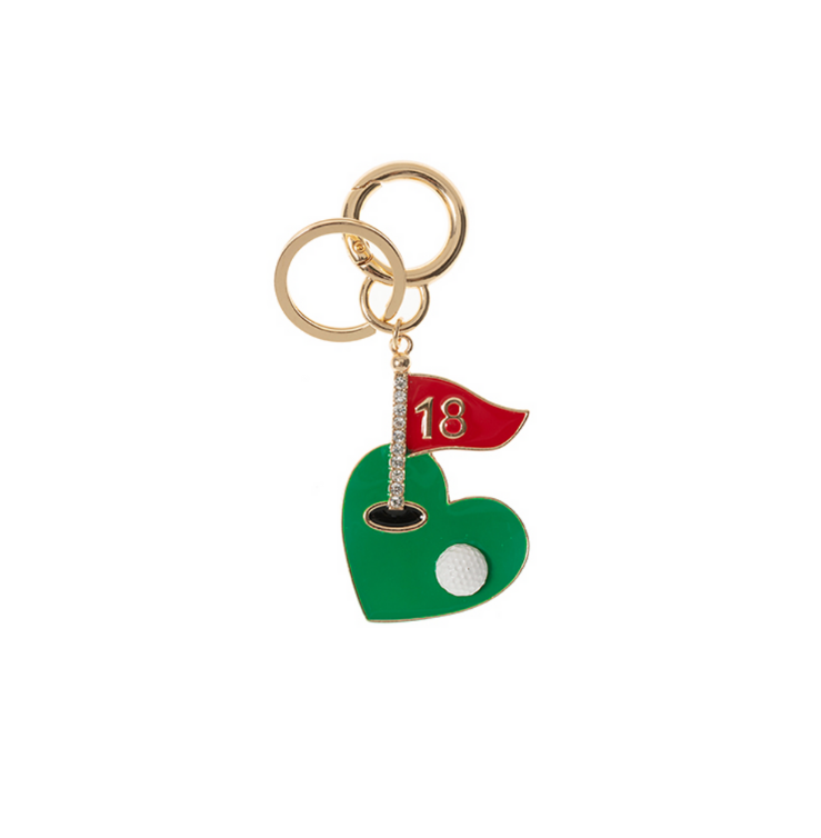 A gold-tone keychain featuring a heart-shaped green, a sparkling crystal-studded flagpole, and a red flag with the number "18," perfect for golf enthusiasts.