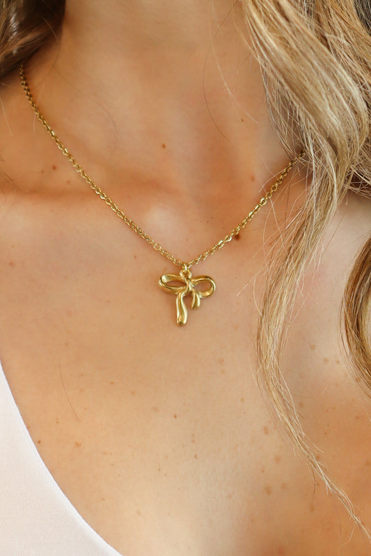 Intricate Bow Necklace with delicate gold bow pendant on a fine chain