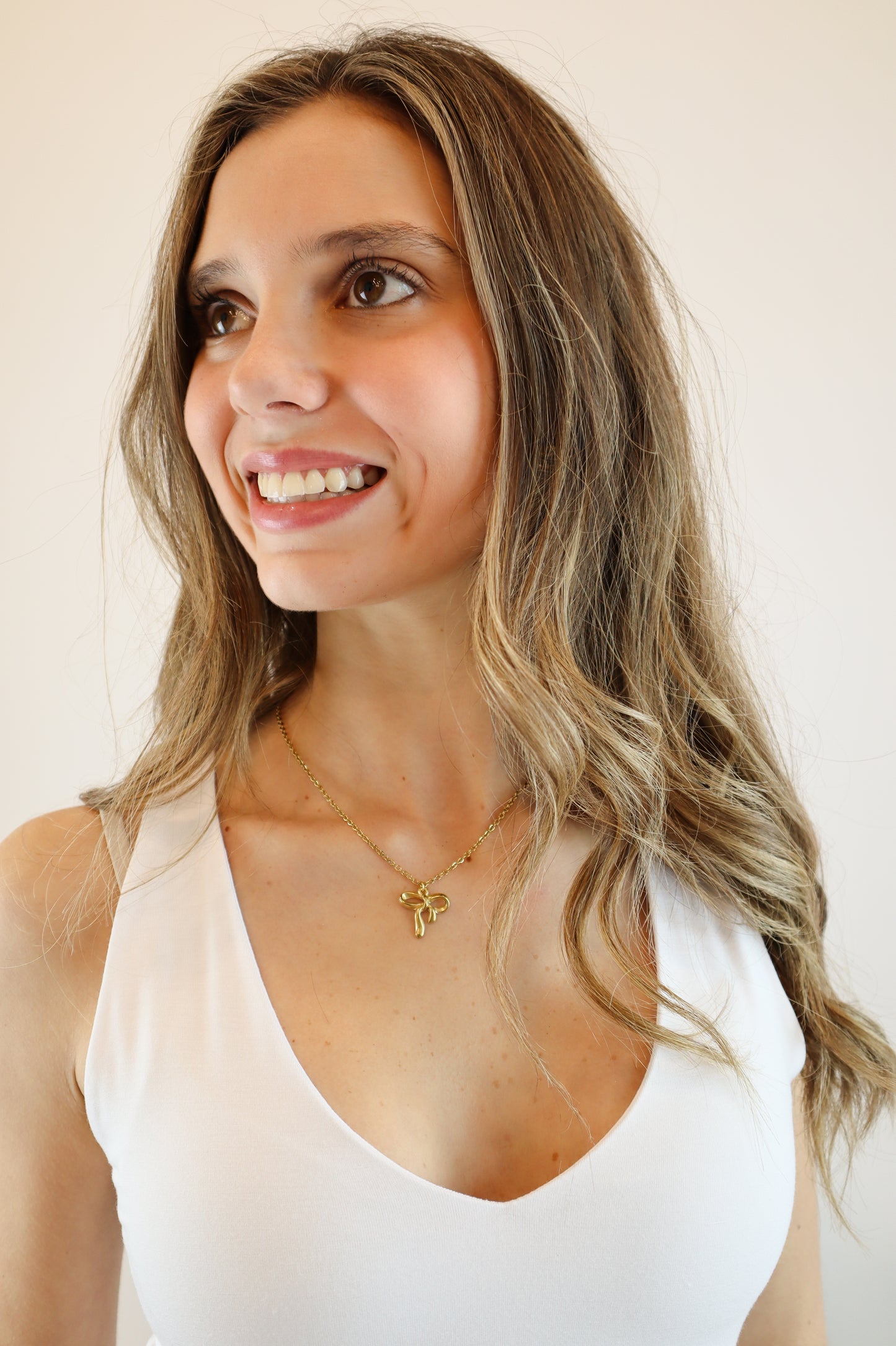 Intricate Bow Necklace with delicate gold bow pendant on a fine chain