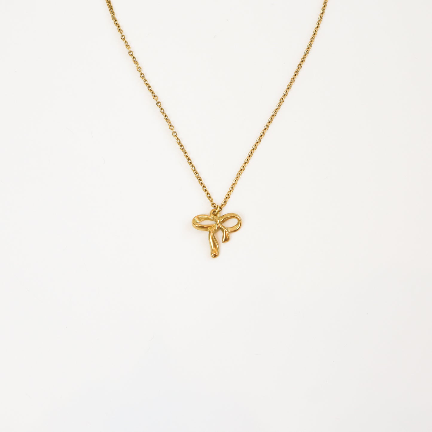 Intricate Bow Necklace with delicate gold bow pendant on a fine chain
