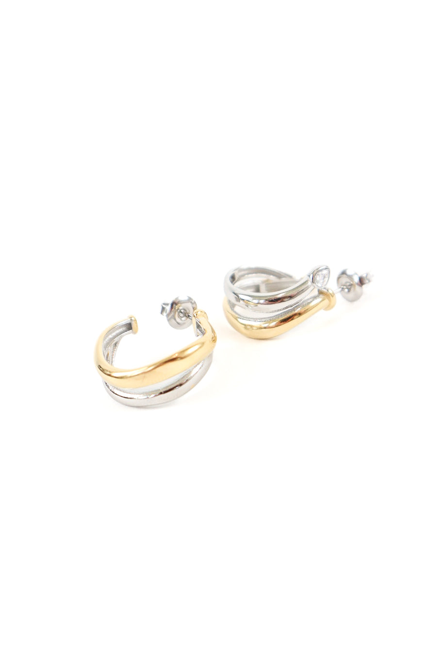 Mixed metal hoop earrings featuring twisted gold and silver layered design with post back closure