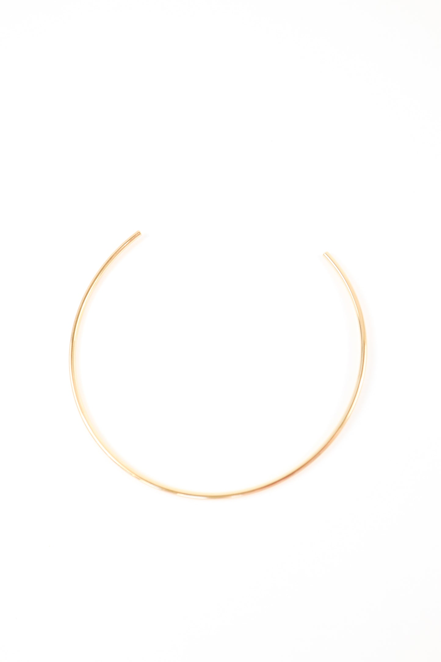 Minimalist gold open collar necklace with sleek high-polish finish