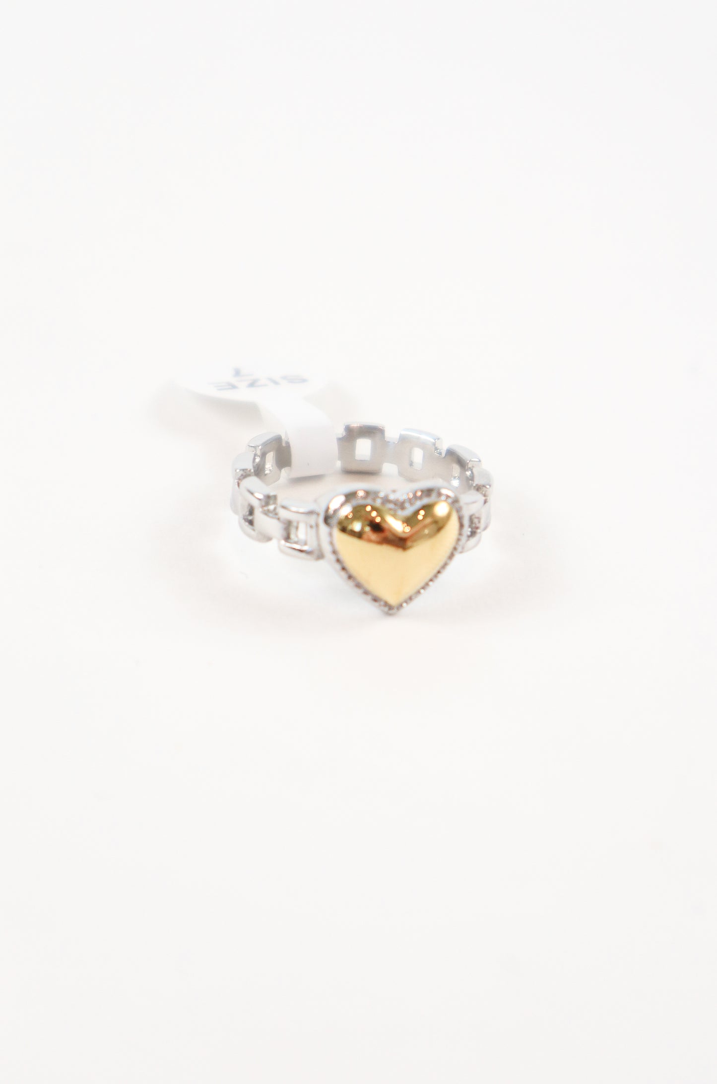 Two-tone heart ring featuring a polished gold heart centerpiece on a silver-tone band with sparkling cubic zirconia accents