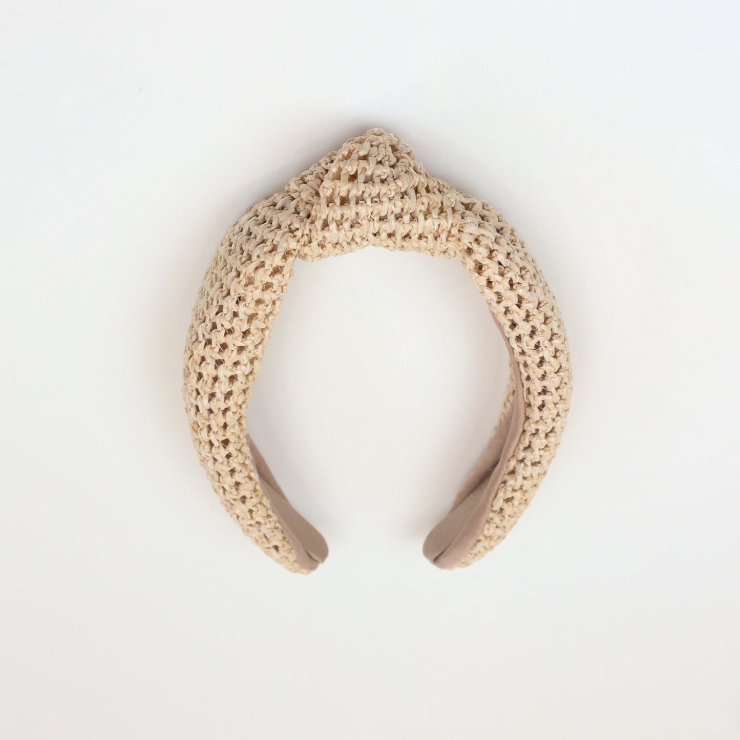 Natural woven rattan headband with a stylish knotted top, perfect for boho-chic fashion lovers
