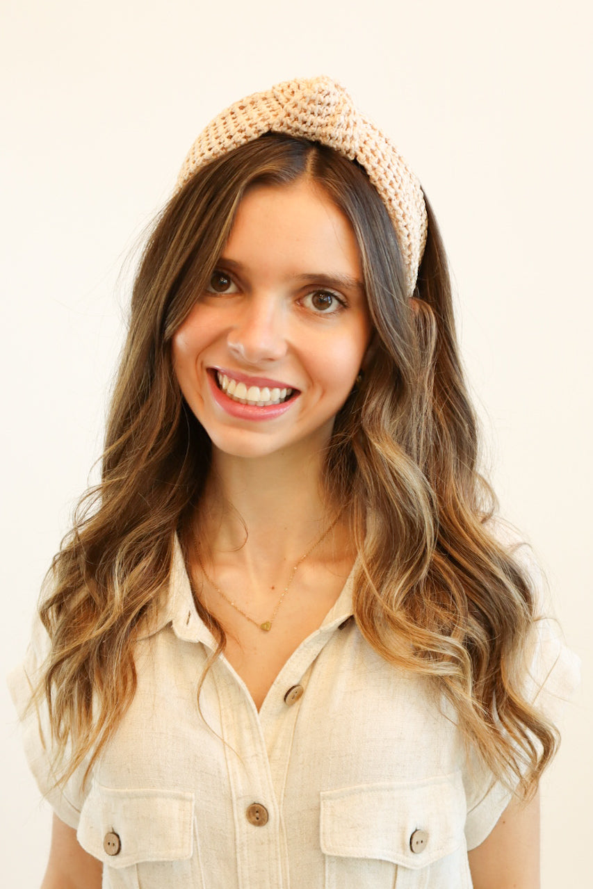 Natural woven rattan headband with a stylish knotted top, perfect for boho-chic fashion lovers