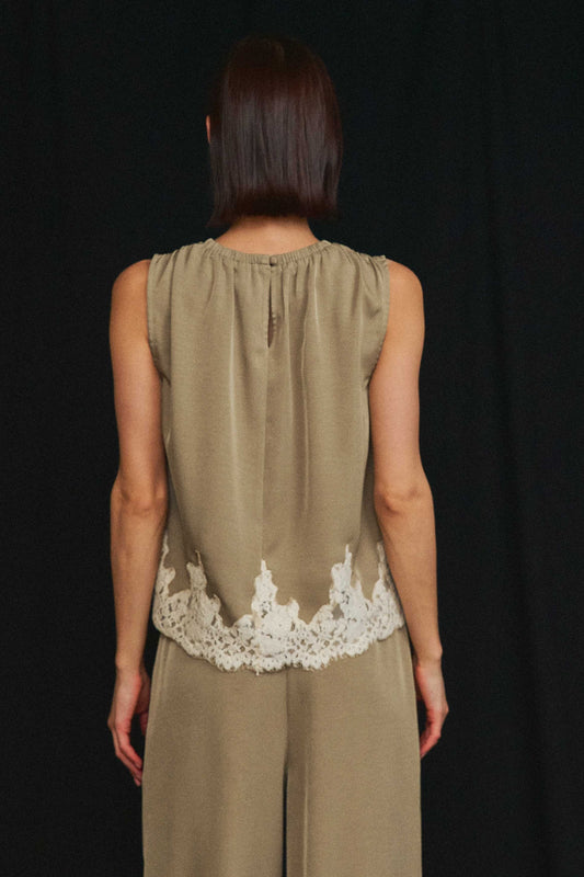 An effortlessly elegant two-piece set featuring delicate lace trim, a gathered neckline, and flowing wide-leg pants for timeless sophistication.