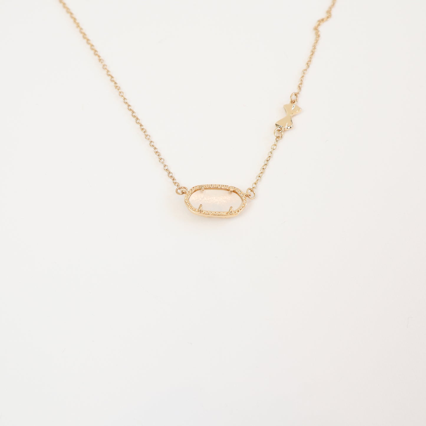 The reverse side of the Love Elise necklace, showcasing an intricate bow-accented openwork design for an alternative styling option.