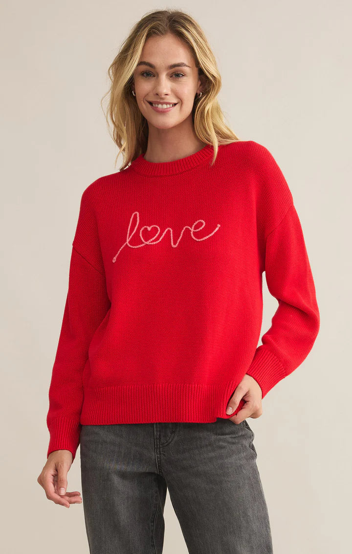 Red oversized boyfriend sweater with embroidered 'love' script, featuring a cozy knit fabric and relaxed fit for a stylish, comfortable look.