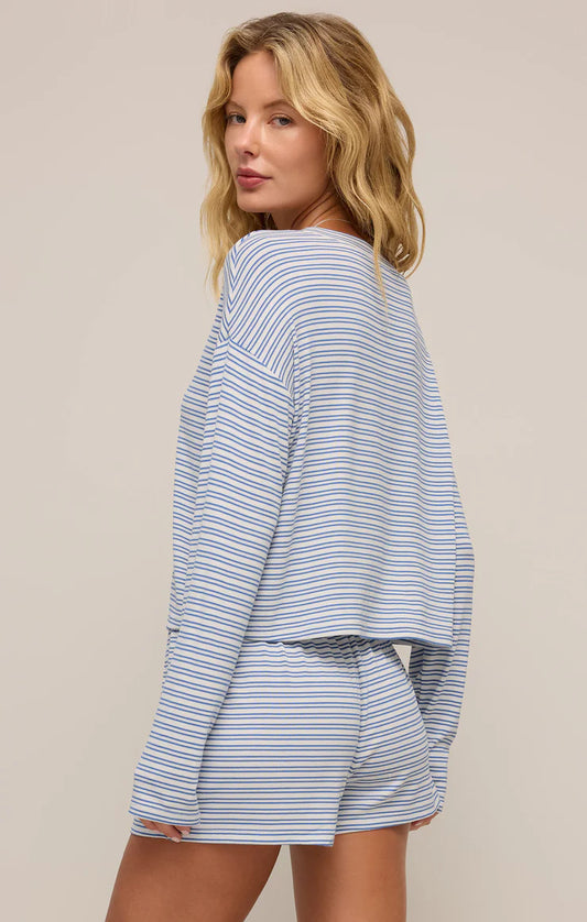 Model wearing the Mara Stripe Modal Cardigan Set, featuring a relaxed-fit button-up top and matching high-waisted shorts in soft blue and white stripes.