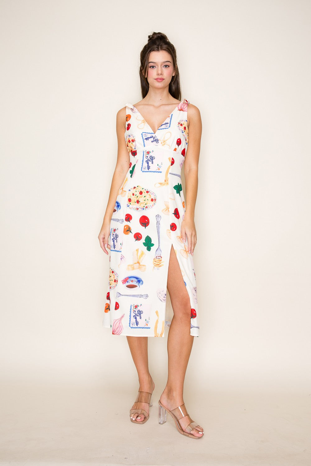Mediterranean-inspired midi dress with bow-tied shoulders and a breezy slit.