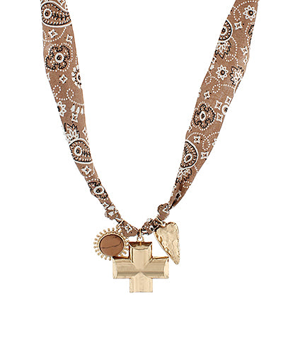 bandana-print fabric necklace with gold-tone charms including a cross, heart, and turquoise medallion, displayed against a white background.