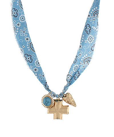 bandana-print fabric necklace with gold-tone charms including a cross, heart, and turquoise medallion, displayed against a white background.