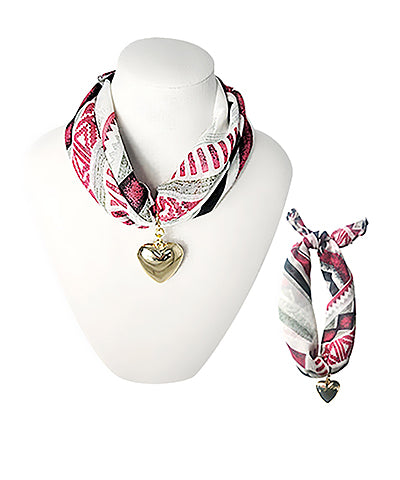 Heart Pendant Scarf Necklace featuring patterned fabric bandana worn as a necklace or bracelet, adorned with a gold heart charm, styled on a mannequin and laid flat for display.