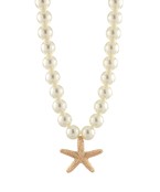 Elegant pearl necklace with a gold-toned starfish charm, perfect for coastal and sophisticated fashion lovers.