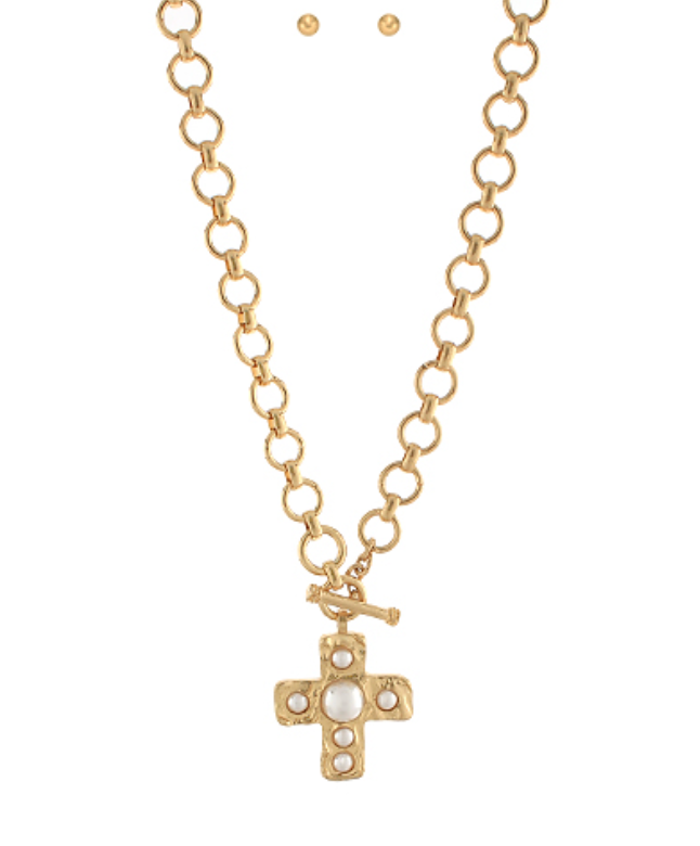 Gold chain necklace with a pearl-adorned cross pendant and toggle clasp, a stylish and symbolic statement piece