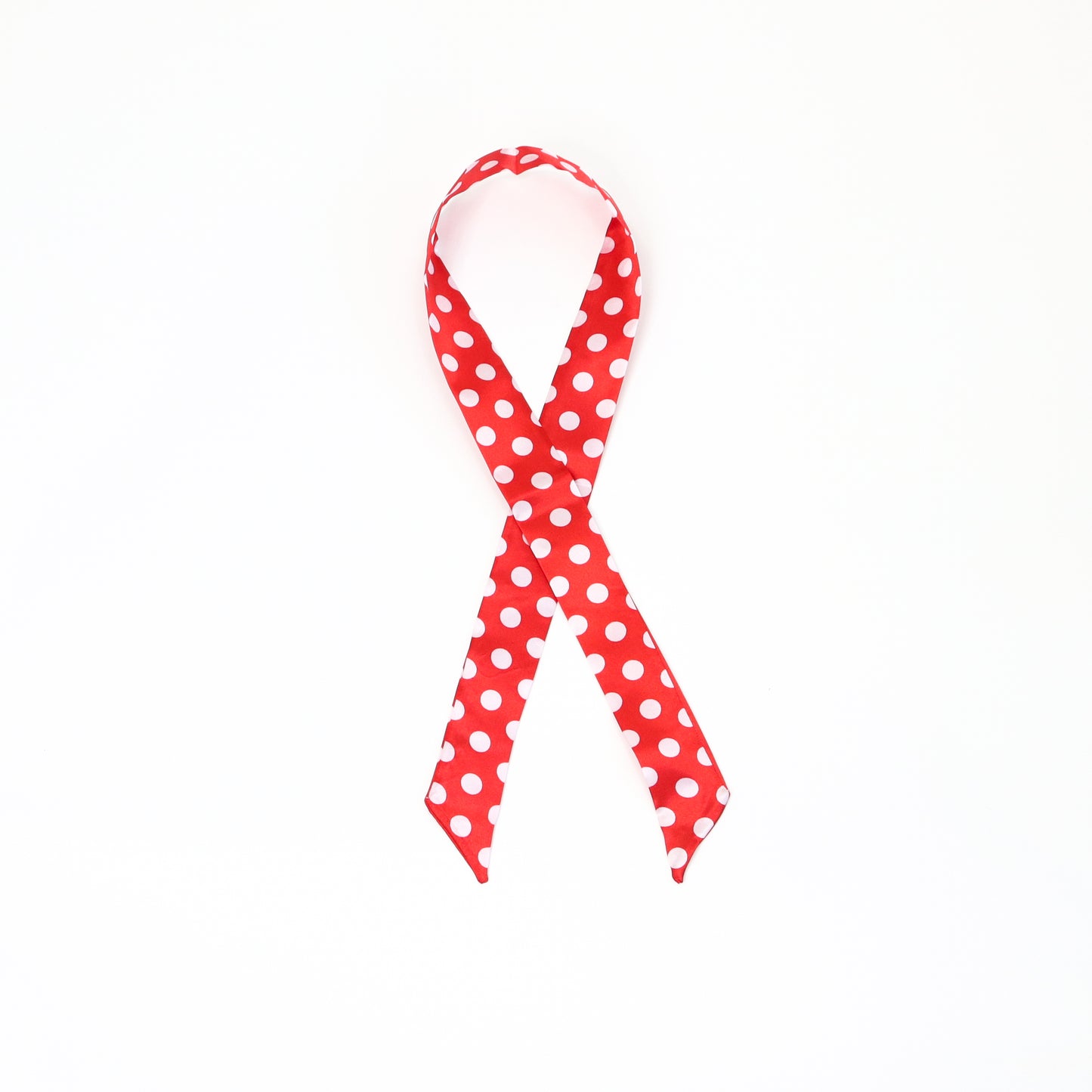 A red twilly scarf featuring white polka dots