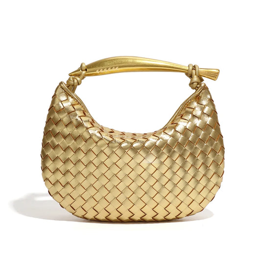 woven leather handbag with a bold gold sculptural handle for a modern, luxury look.