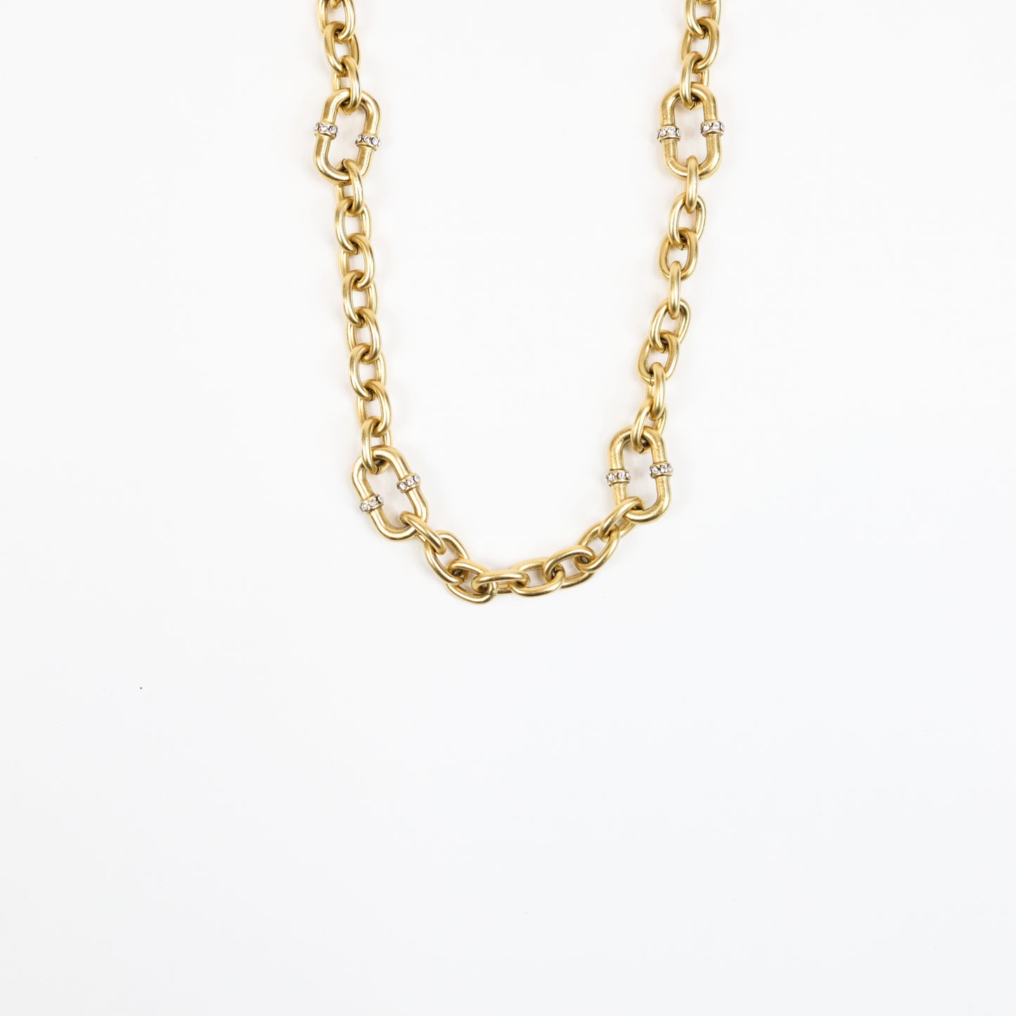 A 22K gold-plated chain necklace featuring bold interlocking links with crystal-accented connectors, exuding luxury and elegance.