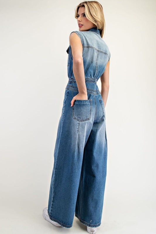 Snow washed sleeveless jumpsuit with button front, chest pockets, and wide leg silhouette.