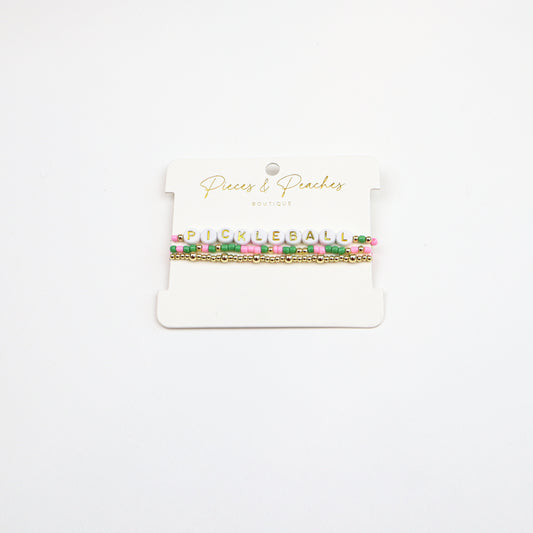 Pickleball Bracelet Stack featuring pink, green, and gold beads with letter beads spelling “PICKLEBALL.