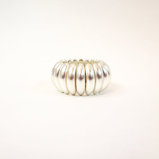 A bold and stylish chunky stretch bracelet featuring dome-shaped panels in gold or silver, adding a statement-making touch to any outfit.