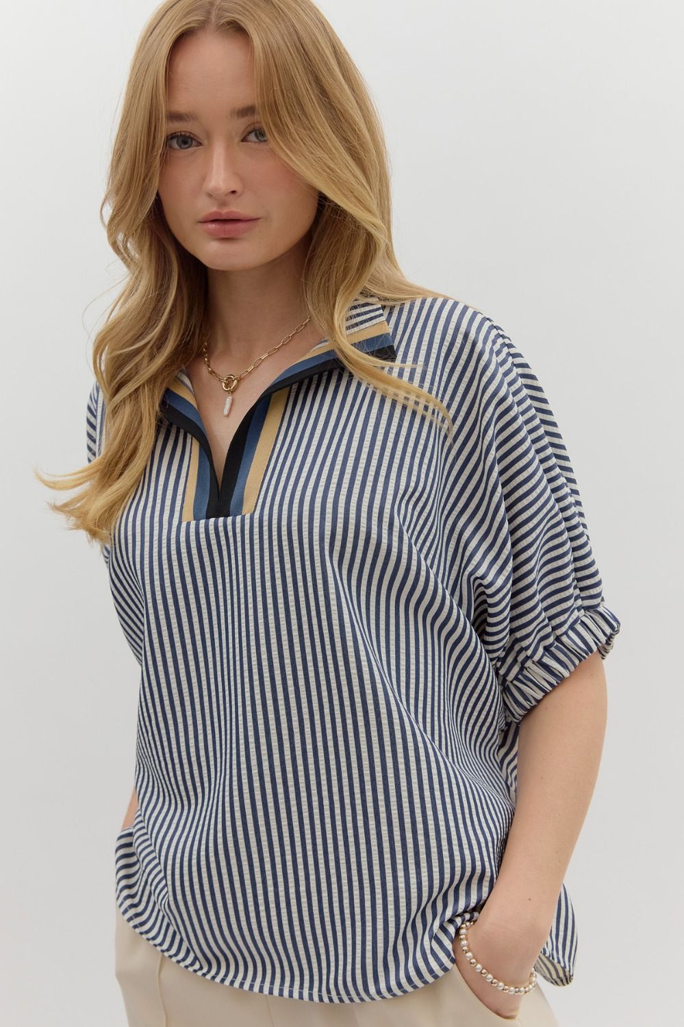 Striped dolman sleeve pullover with multicolor ribbed neck detail.