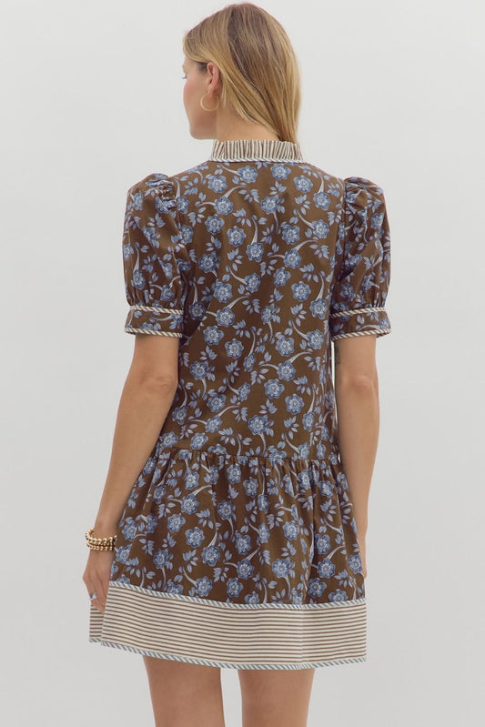 Structured puff sleeve floral mini with contrast hem and ruffle V-neckline.