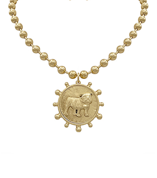 A gold-toned necklace with a beaded chain and a large circular medallion pendant featuring a detailed bulldog illustration, encircled by decorative nubs, all in gold.