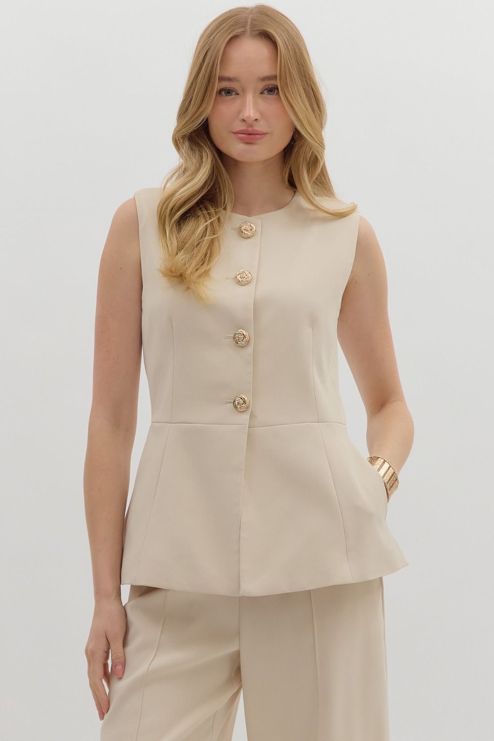 The Cecilia Vest brings timeless tailoring to warm-weather style. This structured, gold-accented sleeveless vest top is perfect for polished everyday looks or elegant evenings out.
